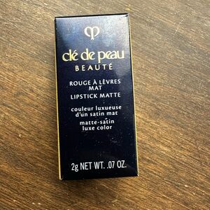 Small .07 cle de peau lipstick in color 103 legend of rouge